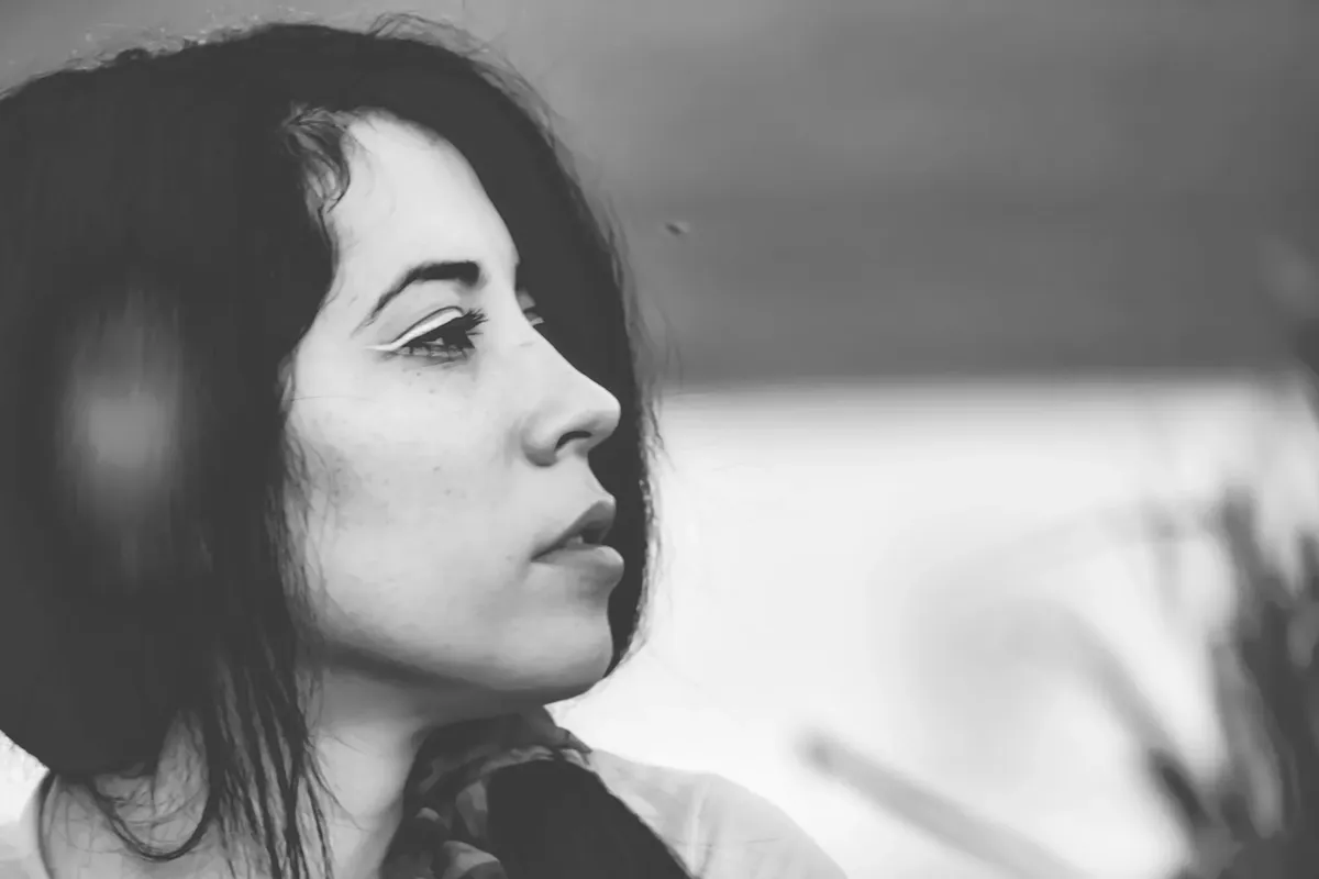 Black and white of young thoughtful female with mouth opened looking away in soft focus