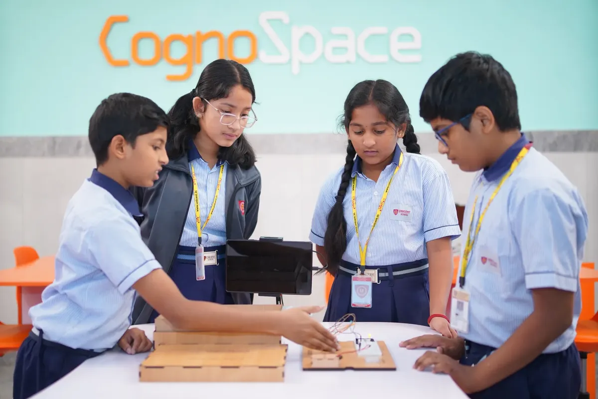 Four students engage in a STEM experiment at CognoSpace, Hyderabad, India.