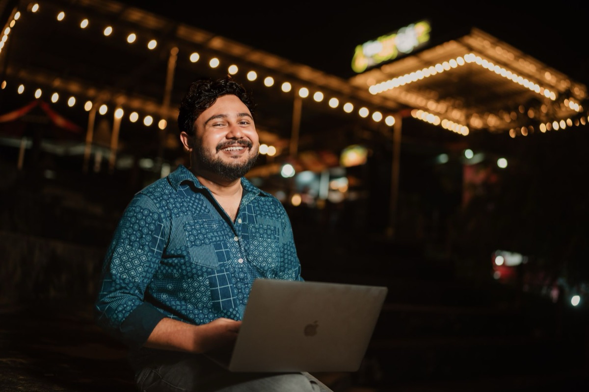 Indian creator with camera and laptop